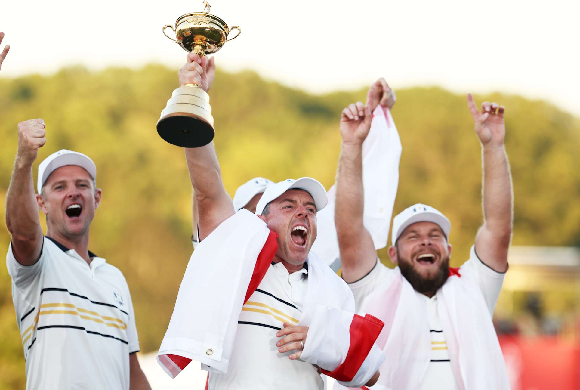 FARMINGDALE, NEW YORK - SEPTEMBER 28: Rory McIlroy of Team Europe raises the Ryder Cup trophy as Team Europe celebrates their 15-13 win over Team United States during the trophy presentation ceremony during the Sunday singles matches of the 2025 Ryder Cup at Black Course at Bethpage State Park Golf Course on September 28, 2025 in Farmingdale, New York. (Photo by Jared C. Tilton/Getty Images)
