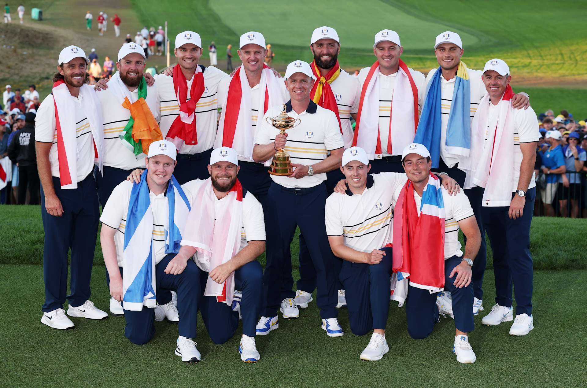 FARMINGDALE, NEW YORK - SEPTEMBER 28: Captain Luke Donald lifts the trophy alongside Shane Lowry, Rasmus Hojgaard, Justin Rose, Jon Rahm, Sepp Straka, Ludvig Aberg, Rory McIlroy, Viktor Hovland, Matt Fitzpatrick, Tommy Fleetwood, Robert MacIntyre and Tyrrell Hatton of Team Europe after their 15-13 win over Team United States during the Sunday singles matches of the 2025 Ryder Cup at Black Course at Bethpage State Park Golf Course on September 28, 2025 in Farmingdale, New York. (Photo by Andrew Redington/Getty Images)