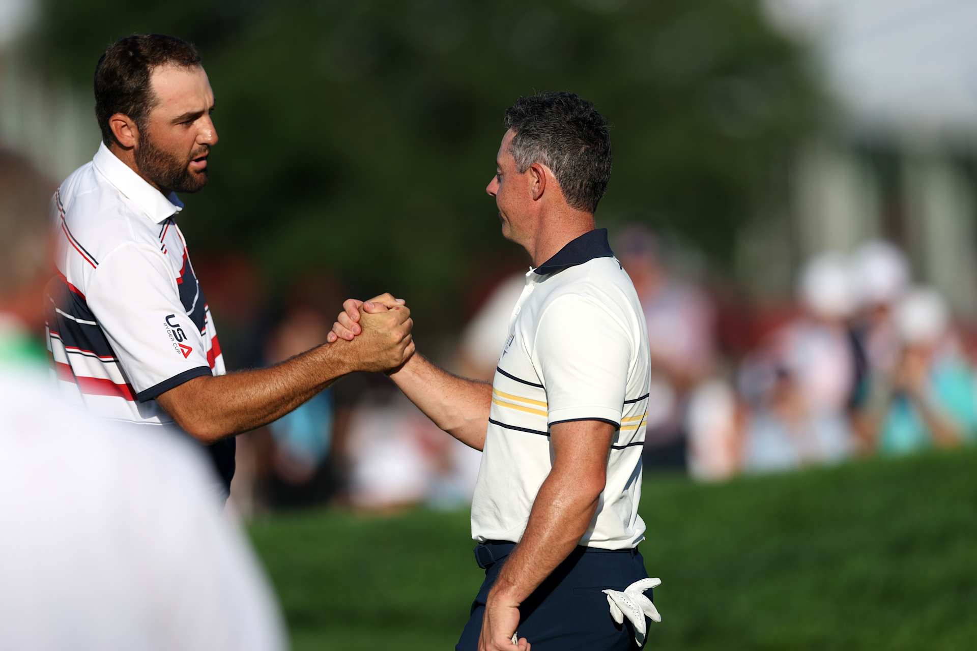 FARMINGDALE, NEW YORK - SEPTEMBER 28: (L-R)  Scottie Scheffler of Team United States and Rory McIlroy of Team Europe shake hands after their match during the Sunday singles matches of the 2025 Ryder Cup at Black Course at Bethpage State Park Golf Course on September 28, 2025 in Farmingdale, New York. (Photo by Carl Recine/Getty Images)