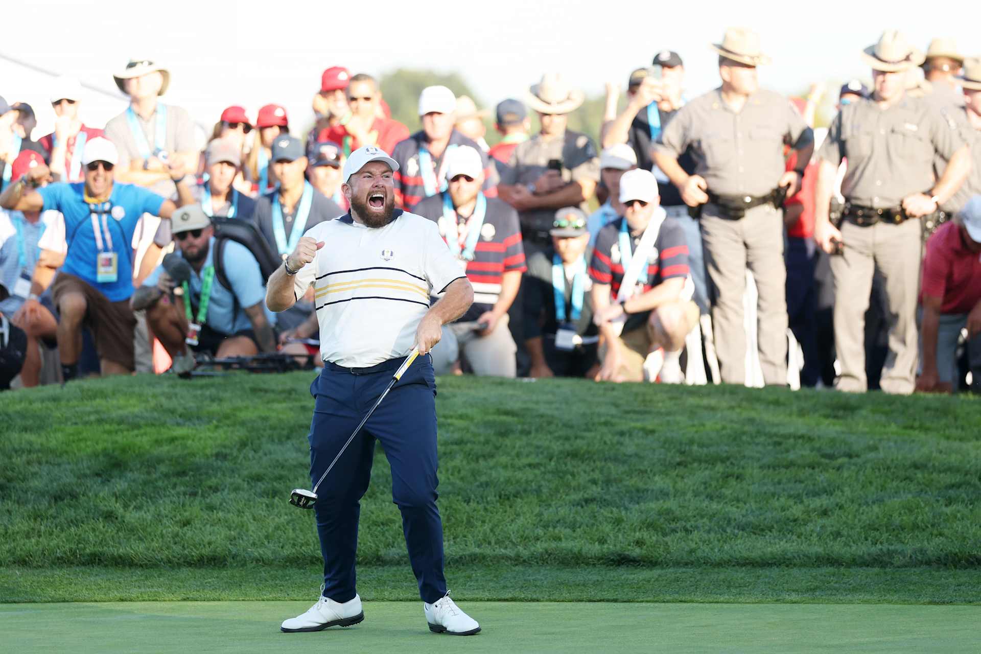 FARMINGDALE, NEW YORK - SEPTEMBER 28: Shane Lowry of Team Europe makes his putt to halve the hole and retain the Ryder Cup on the 18th green during the Sunday singles matches of the 2025 Ryder Cup at Black Course at Bethpage State Park Golf Course on September 28, 2025 in Farmingdale, New York. (Photo by Carl Recine/Getty Images)